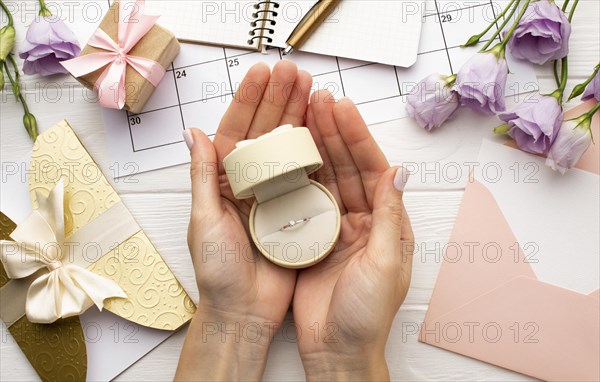 Feminine hands holding wedding ring