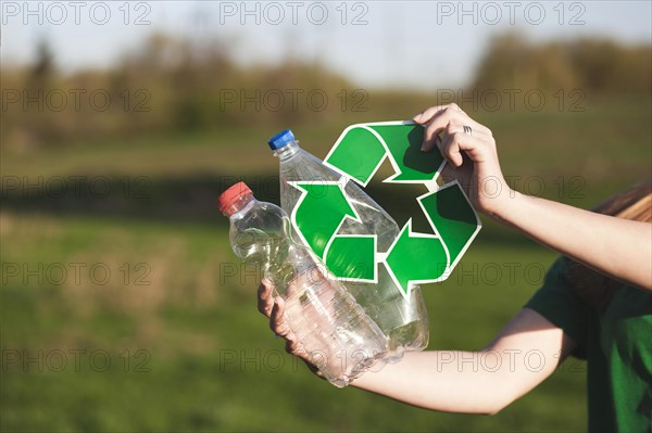 Recycle background with woman holding recycle sign