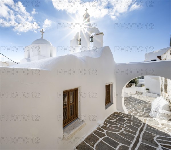 White Greek Orthodox church with sun star