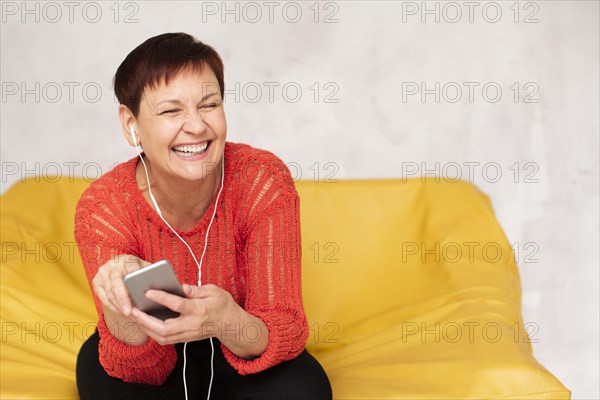 Copy space elder woman listening music