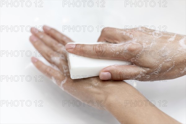 Top view person washing hands with solid soap