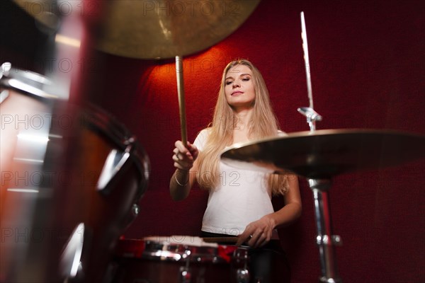 Low view shot girl playing cymbals