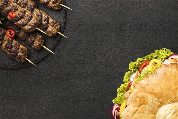 Flat lay tasty kebab slate with copy space