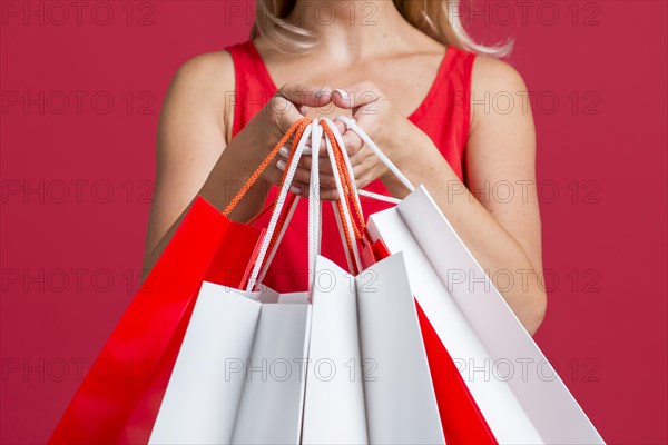 Woman showing off lots shopping bags after shopping spree