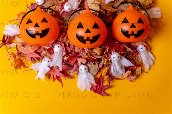 Overhead view of orange Halloween pumpkins on a background of yellow