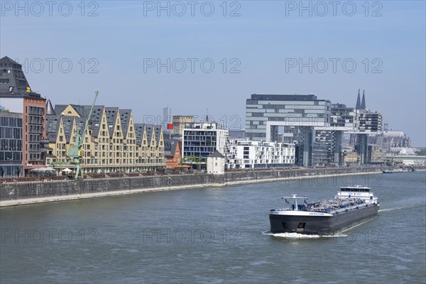 Cargo ship on the Rhine in front of Cologne's Rheinauhafen