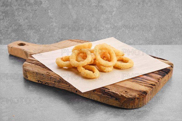 Deep fried spicy onion rings on parchment