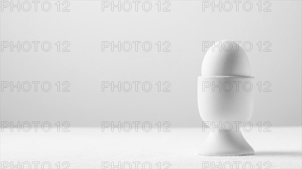 Front view white egg stand with copy space
