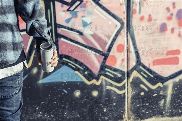 Close up person s hand holding aerosol bottle