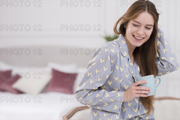 Side view woman home drinking tea