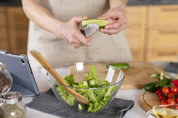 Hands cutting cucumber kitchen