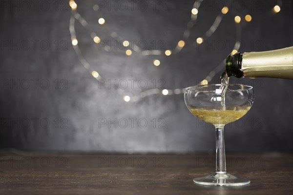 Decoration with pouring champagne glass