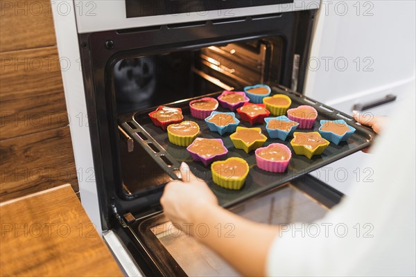 Crop person baking cupcakes