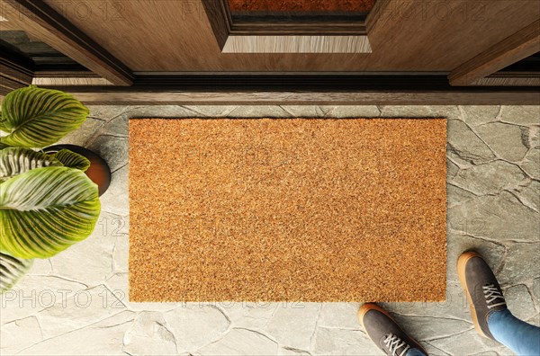 Overhead of blank doormat and shoes of a man standing on the porch at the front door