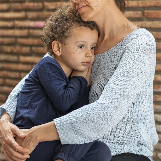 Little boy sad comforted by his mother