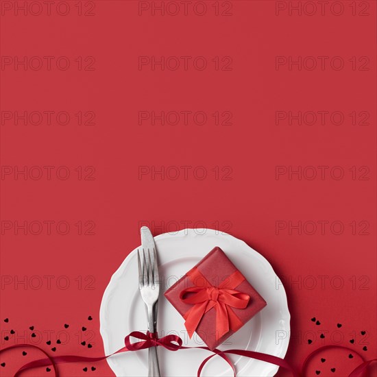 Top view valentine s day gift plate with ribbon cutlery