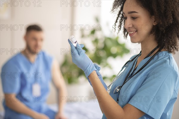 Female doctor preparing vaccination her colleague