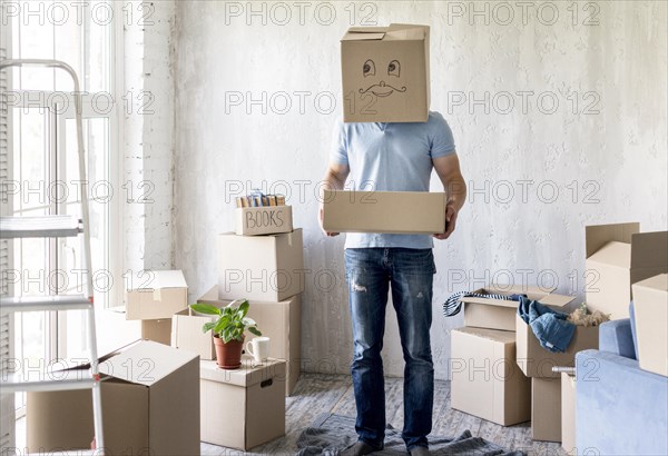 Man with box head while packing move