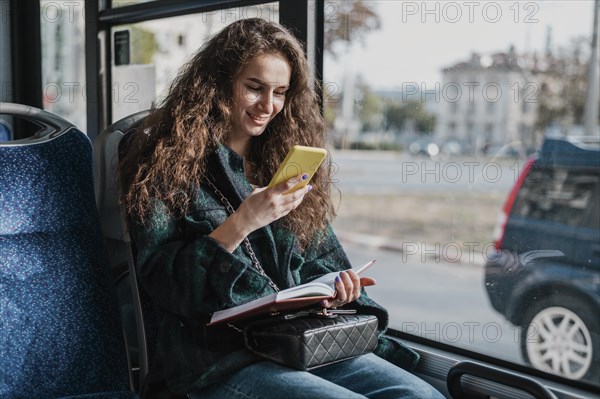 Woman with curly hair travelling with bus