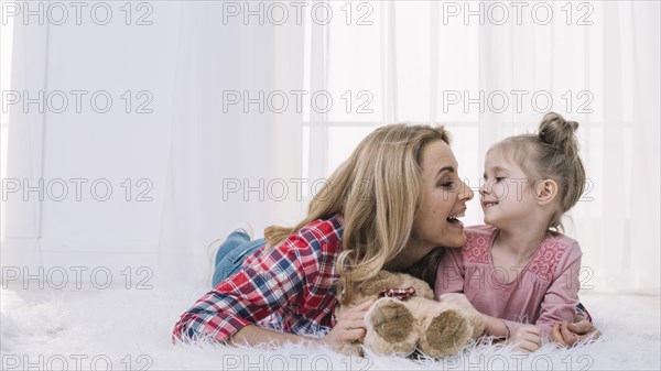 Happy mother daughter looking each other