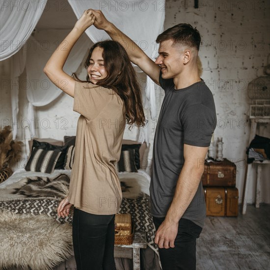 Adorable young couple dancing together