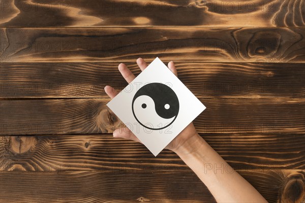 Top view hand holding ying yang symbol