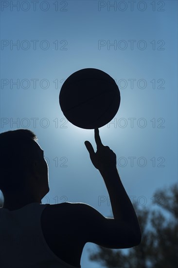 Man spinning basketball finger