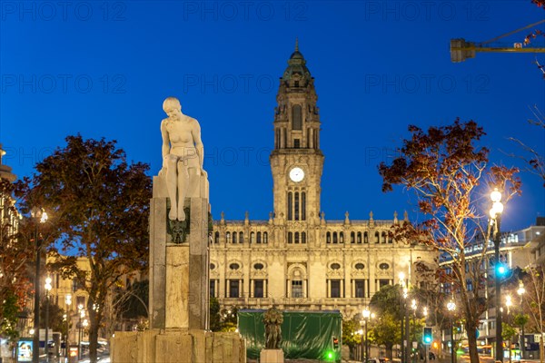 Marble sculpture A Juventude and the Pacos de Concelho City Hall at dusk