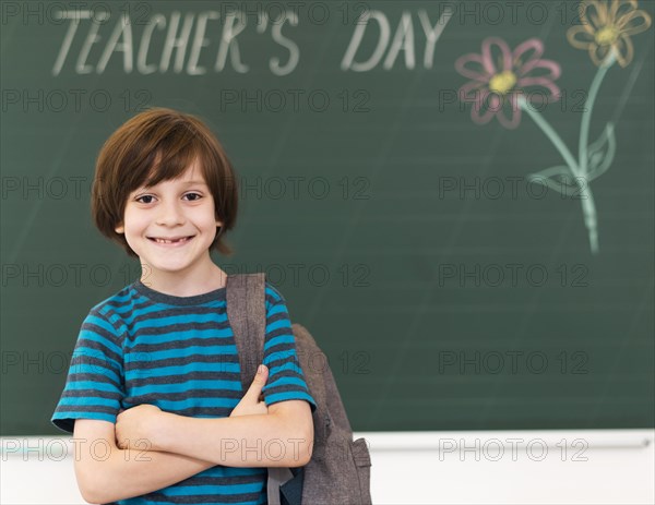 Smiley kid posing blackboard