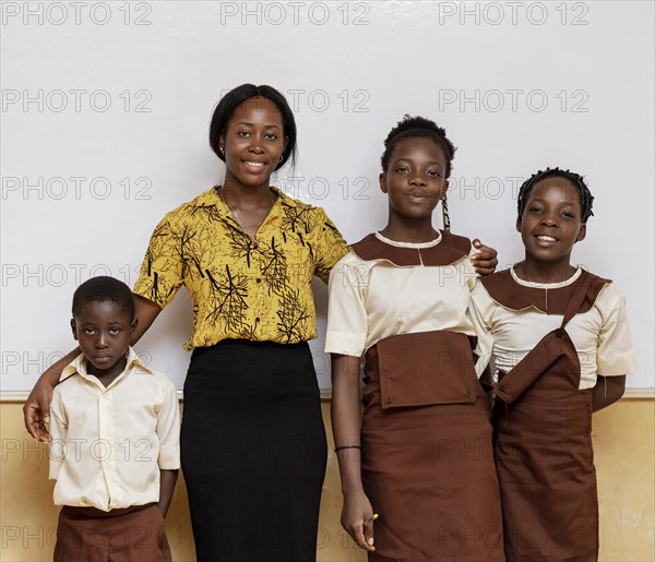 African woman teaching children class