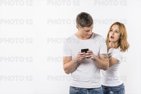 Boyfriend looking her girlfriend secretly looking cellphone