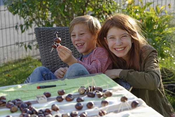 Children tinkering with chestnuts and having fun