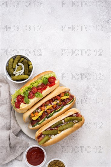 Flat lay delicious hot dogs with vegetables