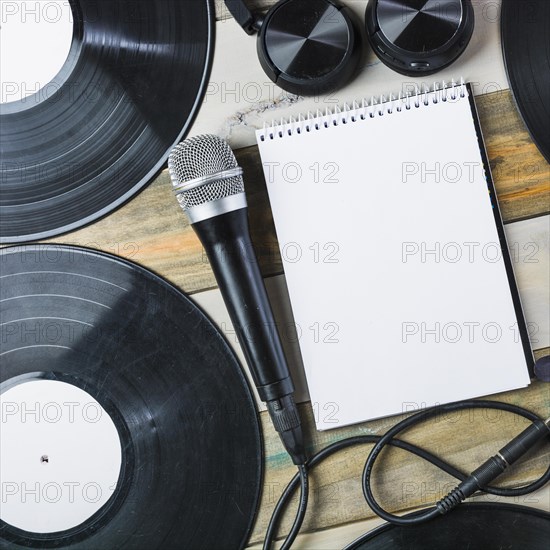 Headphone microphone vinyl record blank spiral notepad wooden table