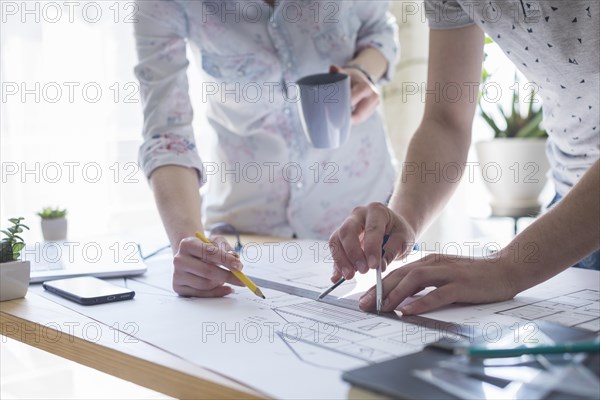 Close up architecture hands working blueprint wooden table office