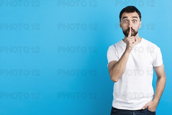 Man making quiet gesture