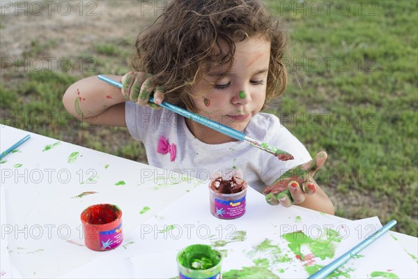 Messy girl painting canvas park