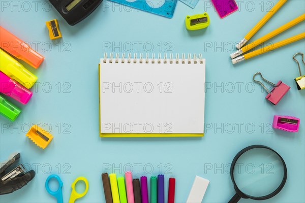 Writing implements laid circle with jotter middle