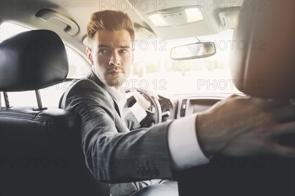 Close up handsome man driving reverse