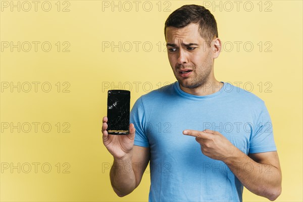Man holding broken phone