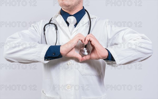 Doctor making heart gesture with hands. Concept of love and medicine