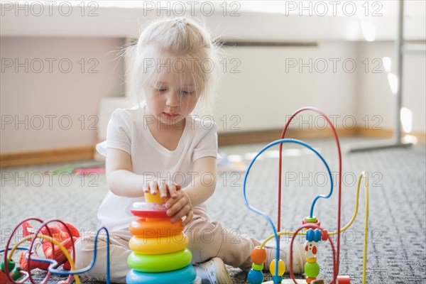 Concentrated kid spending time with toys