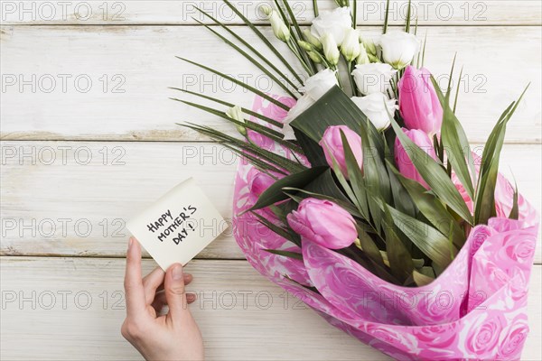 Female hand with holiday card bouquet flowers