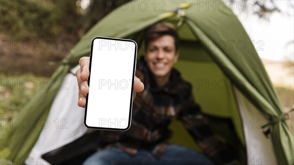 Happy camping man forest copy space mobile phone