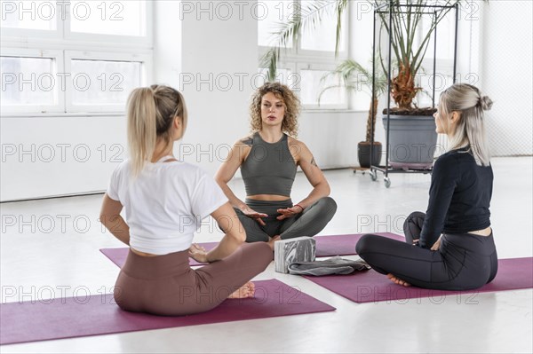 Yoga instructor teaching women