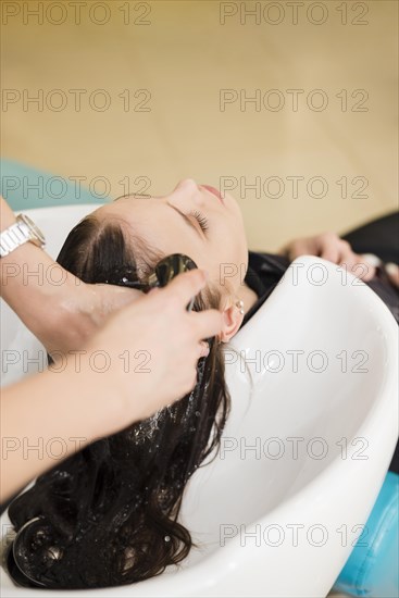 Brunette woman getting her hair washed