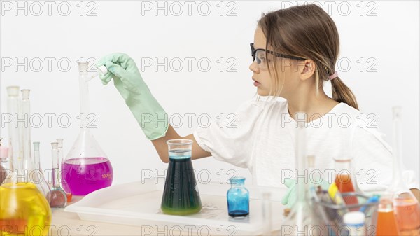 Side view girl doing chemistry experiments