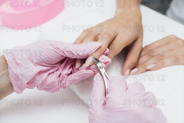 Beautiful woman hands cutting cuticles