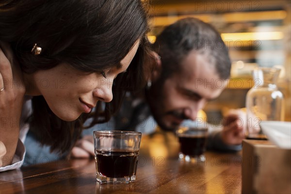 Close up couple smelling cups coffee