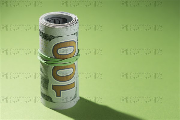 Close up rolled up banknotes green background